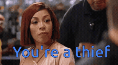 A Woman With Red Hair And The Words You 'Re A Thief Behind Her GIF