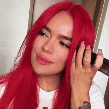 A Woman With Red Hair Has A Tattoo On Her Hand GIF