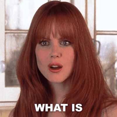 A Woman With Red Hair Has The Words What Is Written On Her Face GIF