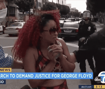 A Woman With Red Hair Is Being Interviewed By A Police Officer On Abc 7 News GIF