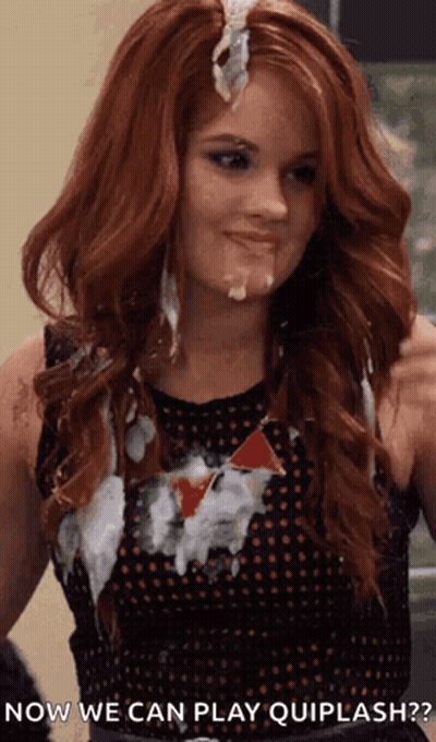 A Woman With Red Hair Is Covered In White Liquid And Says " Now We Can Play Quiplash " . GIF