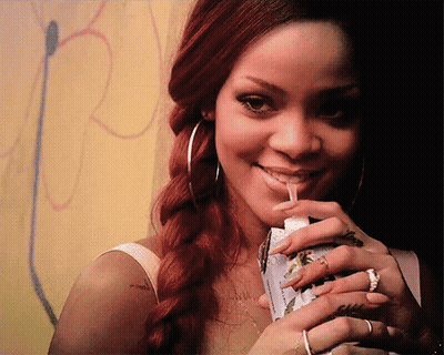 A Woman With Red Hair Is Drinking From A Straw GIF