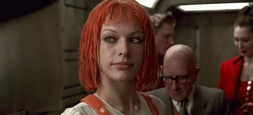 A Woman With Red Hair Is Holding A Badge And A Multipass . GIF