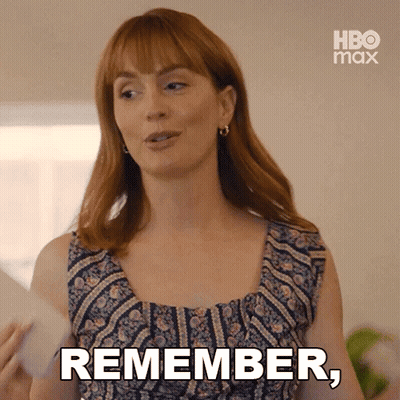 A Woman With Red Hair Is Holding A Piece Of Paper And Says " Remember " GIF