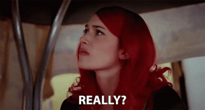 A Woman With Red Hair Is Looking Up And Says Really ? GIF