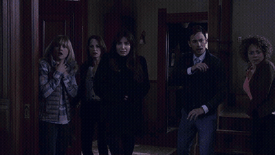 A Woman With Red Hair Is Screaming While Another Woman Stands Behind Her GIF