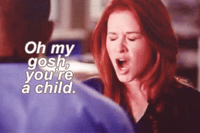 A Woman With Red Hair Is Screaming With The Words Oh My Gosh You 'Re A Child Behind Her GIF