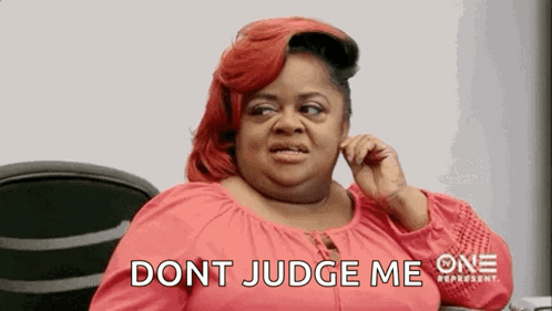 A Woman With Red Hair Is Sitting In A Chair Talking On A Cell Phone And Says `` Dont Judge Me '' . GIF