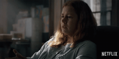 a woman with red hair is sitting in a chair with a netflix logo in the corner