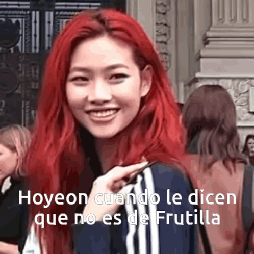 A Woman With Red Hair Is Smiling And Talking In Spanish GIF