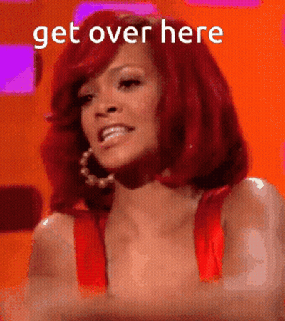 A Woman With Red Hair Is Smiling With The Words Get Over Here Behind Her GIF