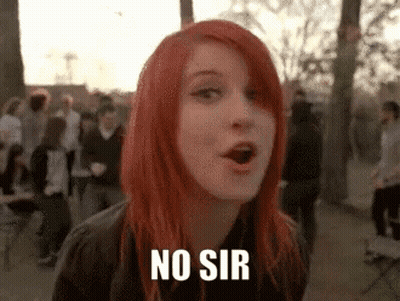 A Woman With Red Hair Is Standing In Front Of A Crowd And Says No Sir . GIF