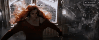A Woman With Red Hair Is Standing In Front Of A Window With A Sign That Says All Powers GIF
