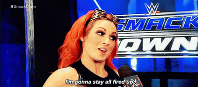 A Woman With Red Hair Is Talking Into A Microphone While Wearing Goggles . GIF
