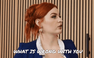 A Woman With Red Hair Is Talking To Someone And The Words What Is Wrong With You Are Above Her GIF