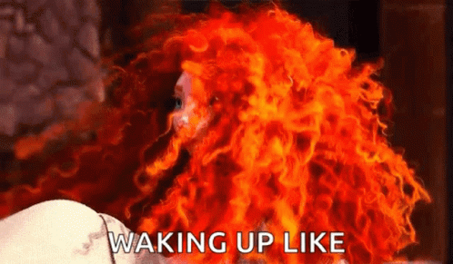 A Woman With Red Hair Is Waking Up Like Fire . GIF