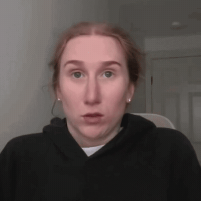 A Woman With Red Hair Is Wearing A Black Hoodie GIF
