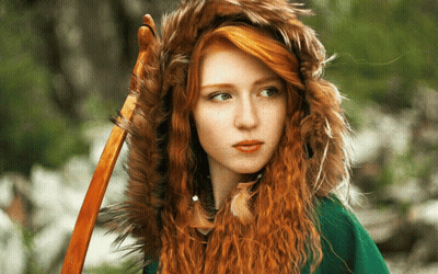 A Woman With Red Hair Is Wearing A Fur Hood GIF