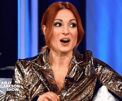 A Woman With Red Hair Is Wearing A Gold Sequined Jacket On The Kelly Clarkson Show . GIF