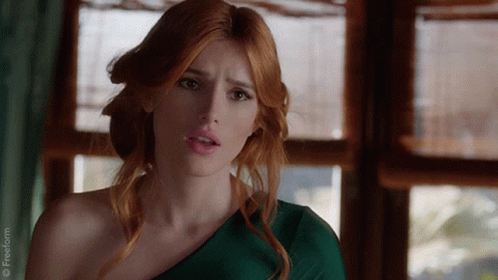 A Woman With Red Hair Is Wearing A Green One Shoulder Dress With A Freeform Logo In The Corner GIF
