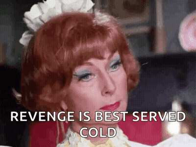A Woman With Red Hair Is Wearing A Maid Costume And Says Revenge Is Best Served Cold . GIF