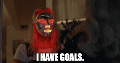 A Woman With Red Hair Is Wearing A Mask And Says I Have Goals GIF