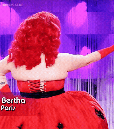 A Woman With Red Hair Is Wearing A Red Dress That Says " Paris " GIF
