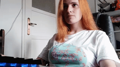 A Woman With Red Hair Is Wearing A T-Shirt That Says " I Love You " GIF