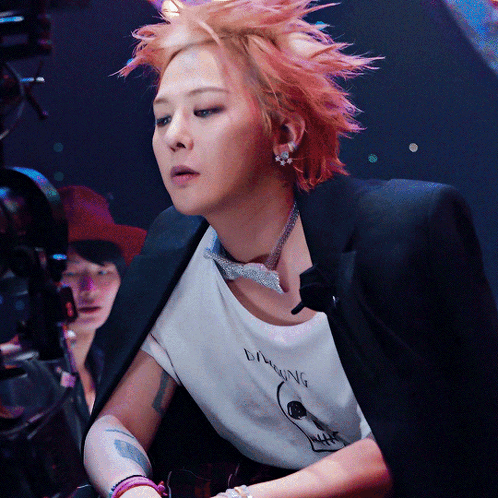 A Woman With Red Hair Is Wearing A T-Shirt That Says Laughing On It GIF