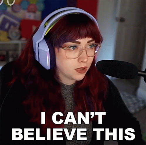 A Woman With Red Hair Is Wearing Headphones And Glasses And Says I Can 'T Believe This GIF