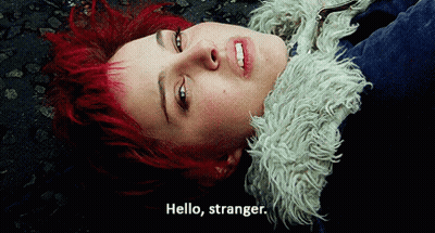A Woman With Red Hair Laying On The Ground With The Words Hello Stranger Below Her GIF