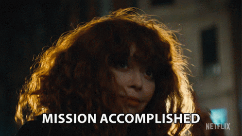 A Woman With Red Hair Says Mission Accomplished On A Netflix Ad GIF