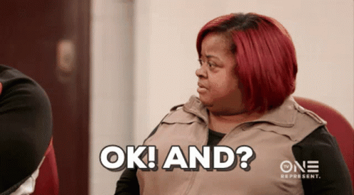 A Woman With Red Hair Says Ok And On A Screen GIF