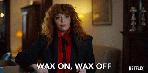 A Woman With Red Hair Says Wax On Wax Off In A Netflix Ad GIF