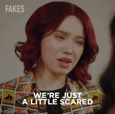 A Woman With Red Hair Says " We 'Re Just A Little Scared " While Wearing A Colorful Jacket GIF