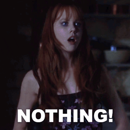 A Woman With Red Hair Stands In Front Of A Sign That Says " Nothing " GIF