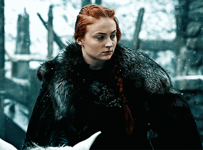 A Woman With Red Hair Wearing A Black Fur Coat GIF