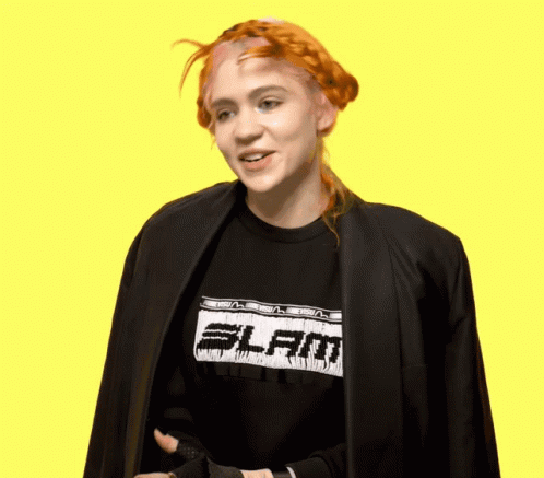 A Woman With Red Hair Wearing A Black Shirt That Says Slam GIF