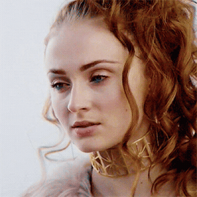 A Woman With Red Hair Wearing A Gold Choker GIF