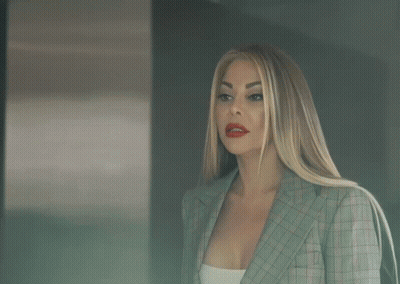A Woman With Red Lips Has A Tattoo On Her Wrist That Says ' X ' GIF