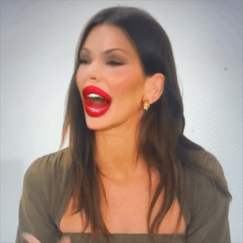 A Woman With Red Lips Is Making A Funny Face With Her Mouth Open GIF