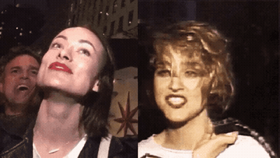 A Woman With Red Lipstick And A Man Laughing In The Background GIF