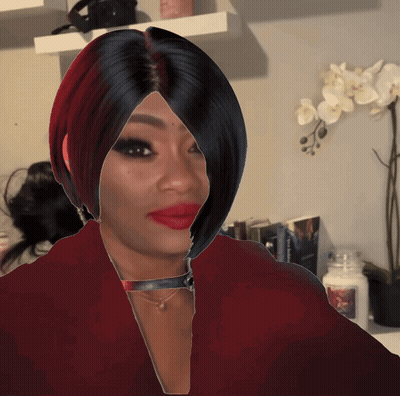 A Woman With Red Lipstick And Black Hair Stands In Front Of A Candle That Says Yankee Candle GIF