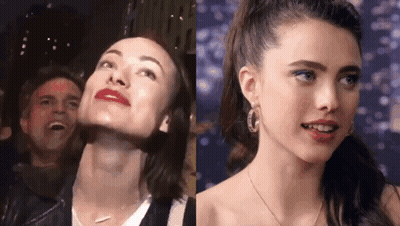 A Woman With Red Lipstick Is Standing Next To A Woman With Blue Eyeliner . GIF