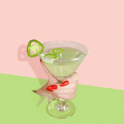 A Woman With Red Nails Holds A Martini With Jalapenos On Top GIF