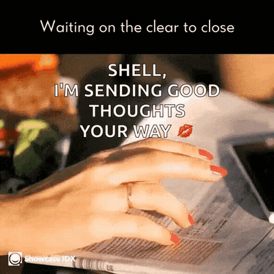A Woman With Red Nails Is Reading A Newspaper With A Kiss On Her Finger GIF