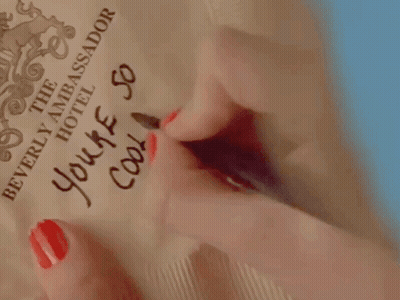 A Woman With Red Nails Writes " You 'Re So Cool " GIF
