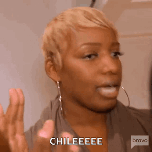 A Woman With Short Blonde Hair And Hoop Earrings Is Making A Funny Face And Saying Chileeeee . GIF