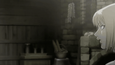 A Woman With Short Blonde Hair Is Standing In Front Of A Brick Wall GIF