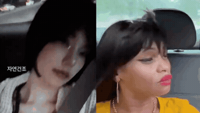 A Woman With Short Hair Is Sitting In A Car Next To Another Woman With Long Hair And Red Lips . GIF